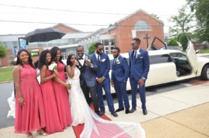 The couple with bridal train and groomsmen