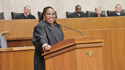 Woman standing in a courtroom