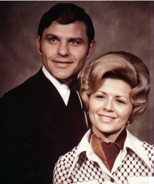 Headshot of a man and his wife standing