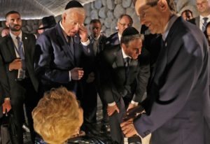 U.S. President Joe Biden reacts next to U.S. Secretary of State Antony Blinken, as Israel's President Isaac Herzog speaks with Holocaust survivor Rena Quint, at the Hall of Remembrance of the Yad Vashem Holocaust Memorial museum in Jerusalem
